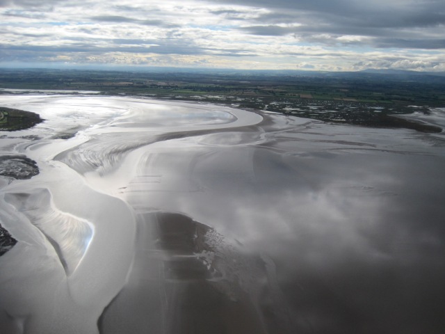 The creeks and pools on Newton Marsh; Moricambe Bay and the channel of the Wampool meandering through the sandbanks between Anthorn and Newton Arlosh